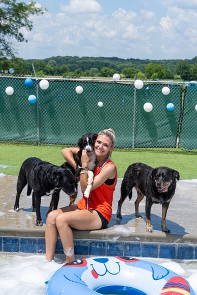 May be an image of swimming and dog